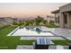 Modern rectangular pool with artificial turf and chaise lounge at 24882 N 124Th St, Scottsdale, AZ 85255