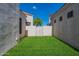 Landscaped side yard with grassy area and gated access at 2223 E Branham Ln, Phoenix, AZ 85042