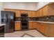 Kitchen with stainless steel appliances and wood cabinets at 2223 E Branham Ln, Phoenix, AZ 85042