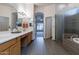 Spacious bathroom with double sinks, soaking tub, and walk-in shower at 2223 E Branham Ln, Phoenix, AZ 85042