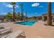 Community pool with lounge chairs and shaded seating areas at 2223 E Branham Ln, Phoenix, AZ 85042