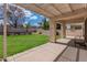 Landscaped backyard with covered patio and grassy area at 2223 E Branham Ln, Phoenix, AZ 85042