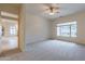 Bright bedroom with large window and ceiling fan at 2223 E Branham Ln, Phoenix, AZ 85042