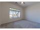 Well-lit bedroom featuring a large window and carpet at 2223 E Branham Ln, Phoenix, AZ 85042