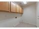 Laundry room with upper cabinets and tile flooring at 2223 E Branham Ln, Phoenix, AZ 85042