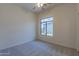 Bright bedroom with large window and plush carpeting at 2223 E Branham Ln, Phoenix, AZ 85042