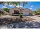 Single-story home with a two-car garage and landscaped yard at 2223 E Branham Ln, Phoenix, AZ 85042
