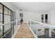 Bright hallway with glass railings and tile flooring at 6413 N 31St St, Phoenix, AZ 85016