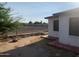 Side yard with gravel and sparse vegetation next to house at 1202 S 14Th St, Phoenix, AZ 85034