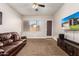 Relaxing living room with leather couch and large TV at 8752 E Plata Ave, Mesa, AZ 85212