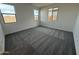 Bright bedroom with neutral carpeting and large windows at 5344 W Manzanita Dr, Glendale, AZ 85302