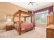 Large main bedroom with a wooden four poster bed and ample closet space at 40010 N Candlewyck Ln, Phoenix, AZ 85086