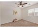 Bright bedroom with ceiling fan, neutral walls, and carpet flooring at 22227 S 214Th St, Queen Creek, AZ 85142