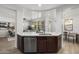 Open kitchen island with white quartz countertop, stainless steel dishwasher, and dark wood cabinets at 17931 N 93Rd Way, Scottsdale, AZ 85255