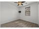 Bright bedroom featuring wood-look floors and a ceiling fan at 17931 N 93Rd Way, Scottsdale, AZ 85255