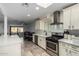 Modern kitchen with white cabinets and stainless steel appliances at 4628 E Holly St, Phoenix, AZ 85008