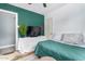 Bedroom with a double bed and teal colored accent wall at 4628 E Holly St, Phoenix, AZ 85008
