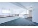 Upstairs loft area with carpet, railing, and ample natural light at 3907 E Ironwood Dr, Phoenix, AZ 85044