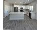 Modern kitchen with white cabinets, stainless steel appliances, and an island at 11428 W Cabrillo Dr, Arizona City, AZ 85123