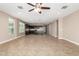 Open living room with tile floors and a view into the kitchen at 37784 W San Sisto Ave, Maricopa, AZ 85138