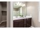 Double vanity bathroom with dark brown cabinets at 37784 W San Sisto Ave, Maricopa, AZ 85138