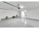 Spacious two-car garage with overhead storage and epoxy floor at 37784 W San Sisto Ave, Maricopa, AZ 85138
