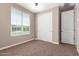 Bright bedroom with window, closet, and neutral wall colors at 37784 W San Sisto Ave, Maricopa, AZ 85138