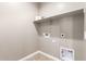 Laundry room with shelving and space for a washer and dryer at 37784 W San Sisto Ave, Maricopa, AZ 85138