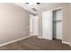 Well-lit bedroom with a closet and neutral colored walls at 37784 W San Sisto Ave, Maricopa, AZ 85138