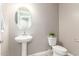 Small bathroom with pedestal sink and toilet at 37784 W San Sisto Ave, Maricopa, AZ 85138