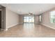 Living room with tile floors and sliding glass doors at 37784 W San Sisto Ave, Maricopa, AZ 85138