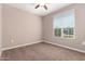 Simple bedroom with large window and neutral decor at 37784 W San Sisto Ave, Maricopa, AZ 85138