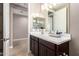 Clean bathroom with double vanity and access to another room at 37784 W San Sisto Ave, Maricopa, AZ 85138