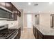 Kitchen with gas range and view into adjacent room at 37784 W San Sisto Ave, Maricopa, AZ 85138