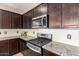 Close-up of kitchen gas cooktop and microwave at 37784 W San Sisto Ave, Maricopa, AZ 85138