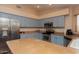 Modern kitchen with stainless steel appliances and light blue cabinets at 5960 E Grapevine Rd, Cave Creek, AZ 85331