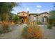 Stunning exterior with stone facade, desert landscaping, and a welcoming entryway at 10904 E Scopa Trl, Scottsdale, AZ 85262