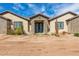 Single-story home with stone facade and double doors at 11620 S 217Th Ave, Buckeye, AZ 85326