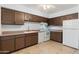 Kitchen with brown cabinets and tile flooring at 18001 N 43Rd Way, Phoenix, AZ 85032