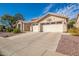 House exterior with two-car garage and desert landscaping at 5960 W Via Montoya Dr, Glendale, AZ 85310