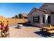 Spacious backyard with a patio, fire pit, and picnic table at 25948 W Oraibi Dr, Buckeye, AZ 85396