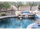 Inviting pool with waterfall feature and spacious patio area at 10683 E Saddle Blanket Trl, Gold Canyon, AZ 85118