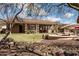 Landscaped backyard oasis with a spa and covered patio at 10683 E Saddle Blanket Trl, Gold Canyon, AZ 85118