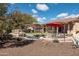 Relaxing pool area with a red umbrella and patio furniture at 10683 E Saddle Blanket Trl, Gold Canyon, AZ 85118