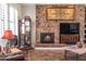 Living room with a stone fireplace, large TV, and comfortable seating at 10683 E Saddle Blanket Trl, Gold Canyon, AZ 85118
