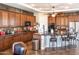 Large kitchen with island, dark wood cabinets, and granite countertops at 10683 E Saddle Blanket Trl, Gold Canyon, AZ 85118