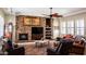 Spacious living room with a stone fireplace and built-in entertainment center at 10683 E Saddle Blanket Trl, Gold Canyon, AZ 85118