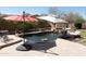 Relaxing pool with two umbrellas and a large patio at 10683 E Saddle Blanket Trl, Gold Canyon, AZ 85118