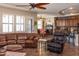 Open living space with a leather sectional and adjacent kitchen at 10683 E Saddle Blanket Trl, Gold Canyon, AZ 85118