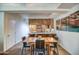 Bright dining area with wood table and chairs, view into kitchen at 7161 E Rancho Vista Dr # 2002, Scottsdale, AZ 85251